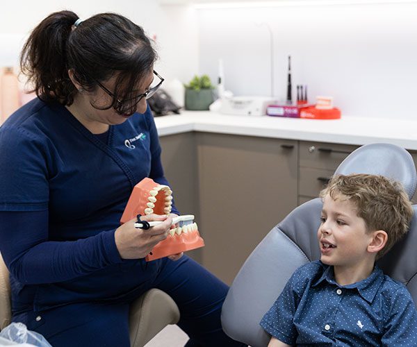 Dentist treating a young patient during a children's dentistry visit